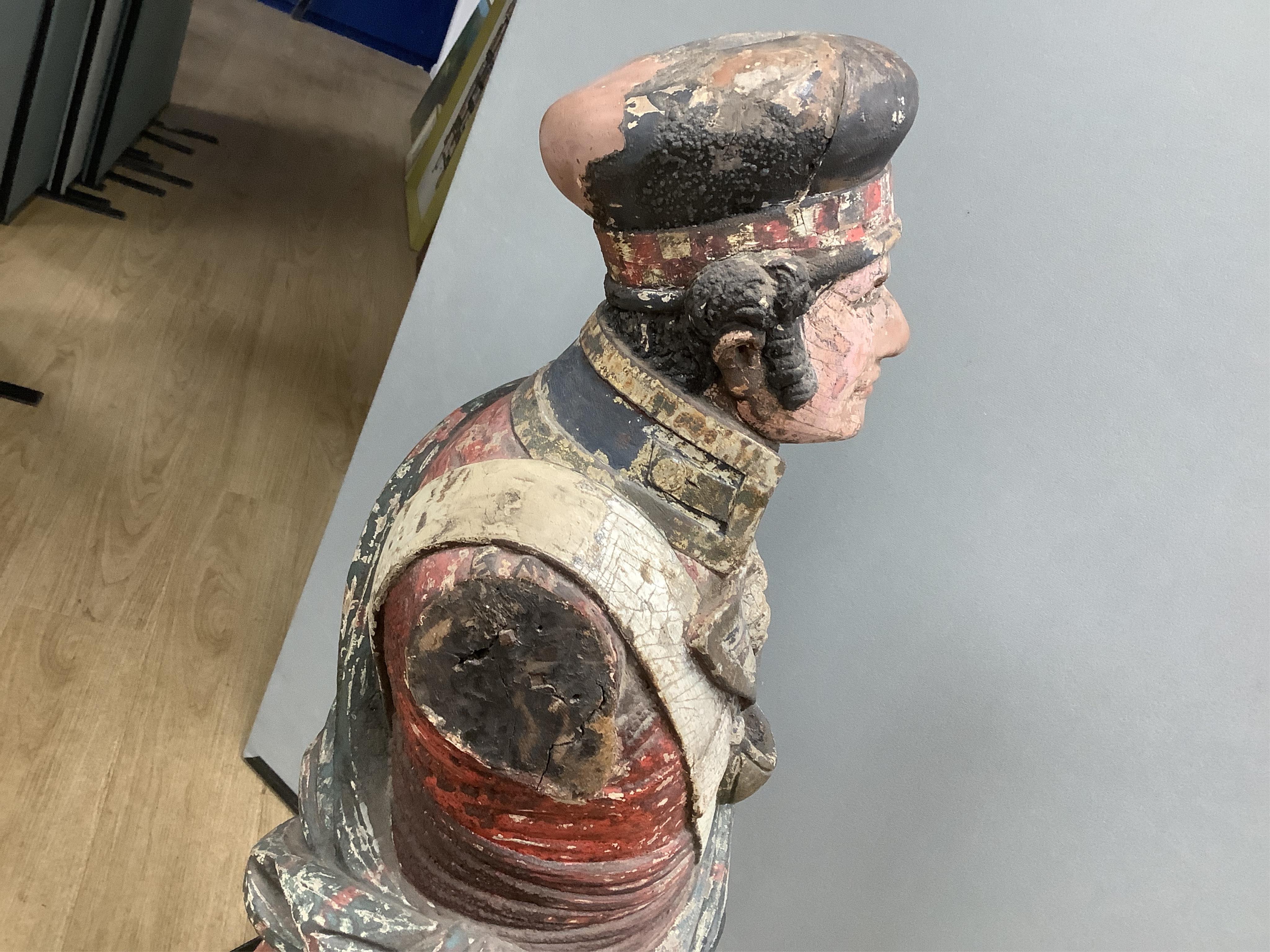 A large 19th century carved and painted Highlander ‘Snuff’ shop advertising figure. 109cm high. Condition - paint work and base weathered, arms detached.